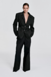 Front view of model wearing a black tailored blazer with structured shoulders and waist-defining shaping by KimC Studio.