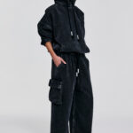 Enzyme-washed black denim hoodie with oversized fit, dropped shoulders, cropped hem, hood ties, and contrast stitching by KimC Studio.