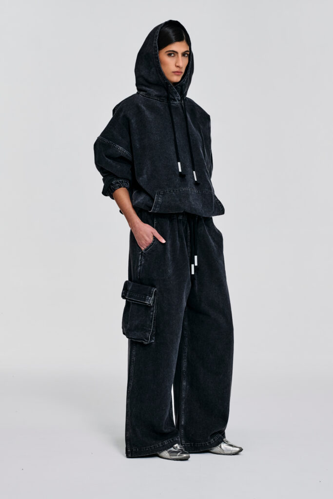 Enzyme-washed black denim hoodie with oversized fit, dropped shoulders, cropped hem, hood ties, and contrast stitching by KimC Studio.