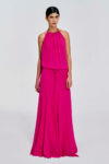 Model wearing a gathered halter maxi dress with relaxed blouson bodice, adjustable waist tie, satin lining and bias-cut floor-length skirt by KimC Studio.