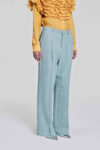 Model wearing pale blue straight-leg linen pants by KimC Studio.