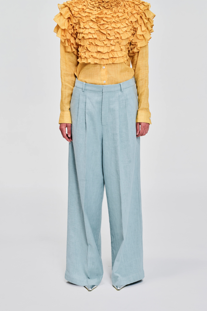 Front view model wearing pale blue wide-leg linen pants by KimC Studio.