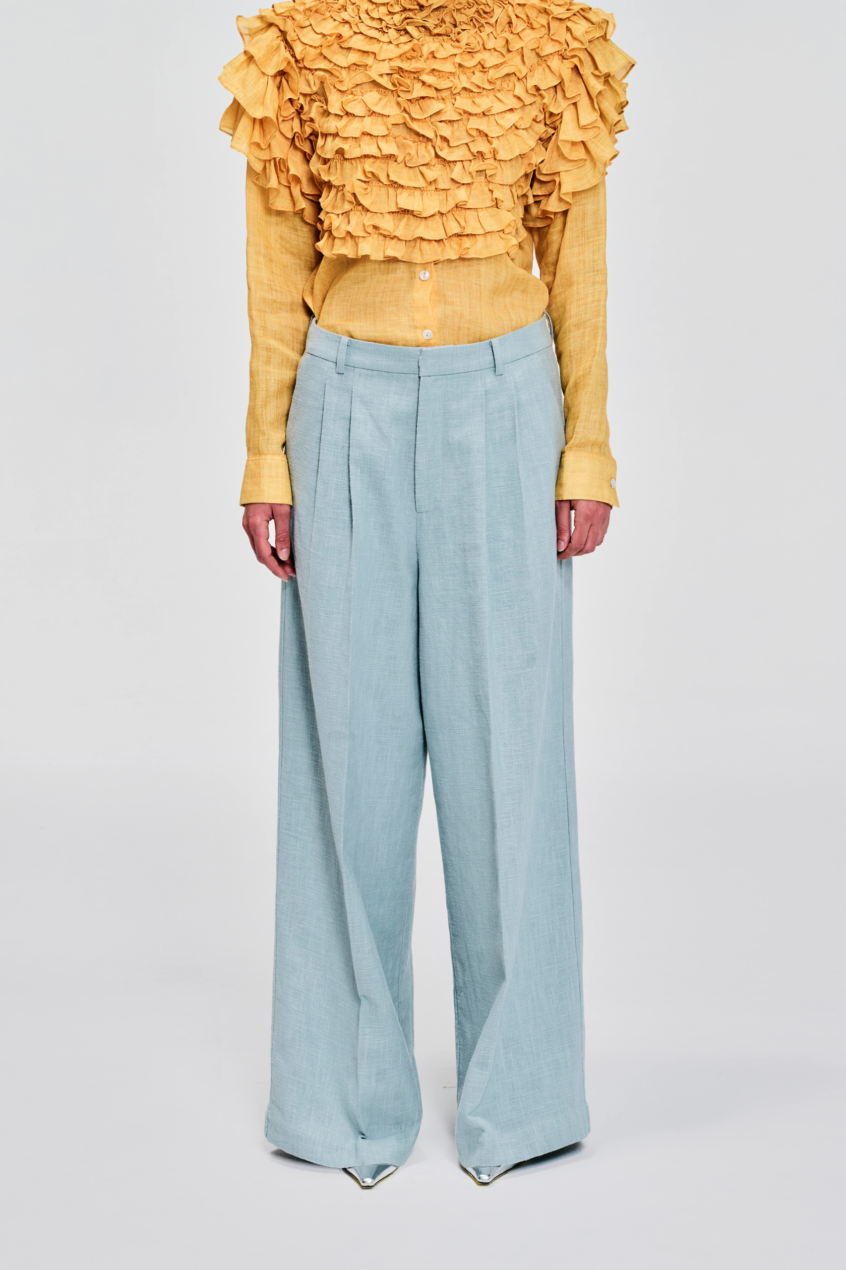 Front view model wearing pale blue wide-leg linen pants by KimC Studio.