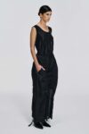 side view of Model wearing a black silk parachute skirt with ruched centre-front detailing, side pockets, and elongated ties by KimC Studio.