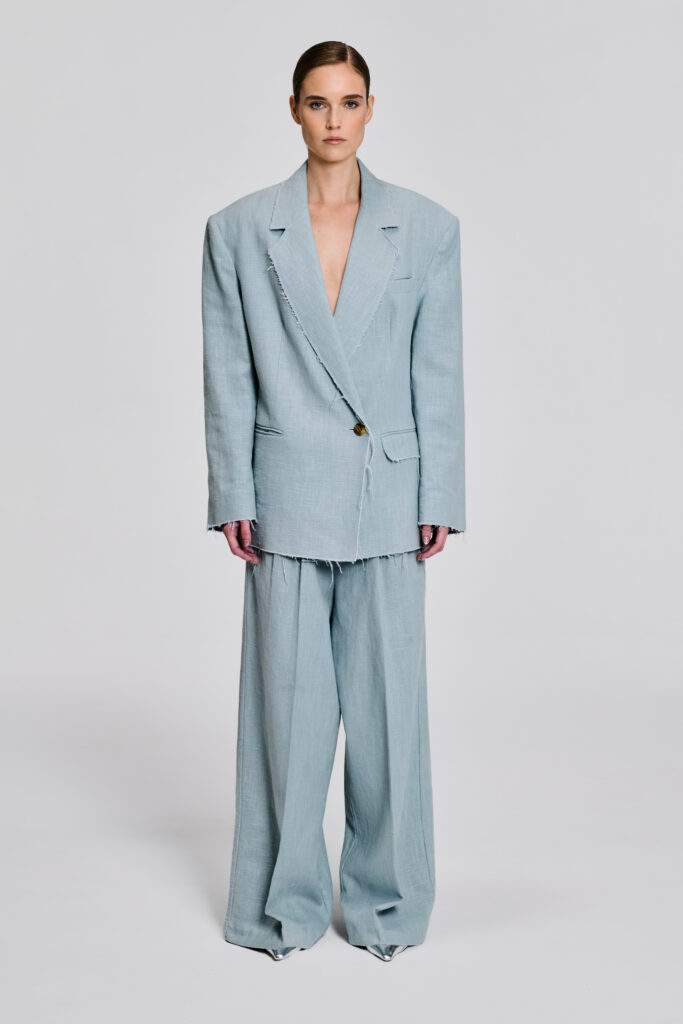 Front view of model wearing a pale blue linen blazer and wide-leg trouser suit by KimC Studio.