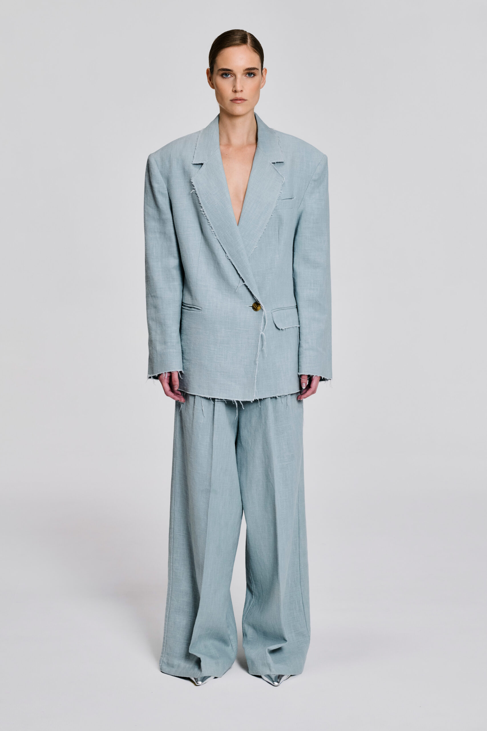 Front view of model wearing a pale blue linen blazer and wide-leg trouser suit by KimC Studio.