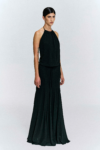 Model wearing a gathered halter maxi dress with
