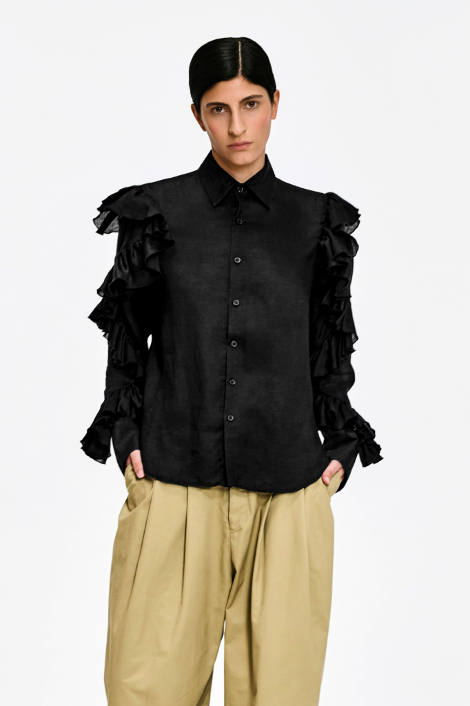 Model wearing KIM C STUDIO black linen ruffle-sleeve shirt