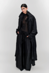 Model wearing a black silk longline coat with a double collar by KimC Studio.