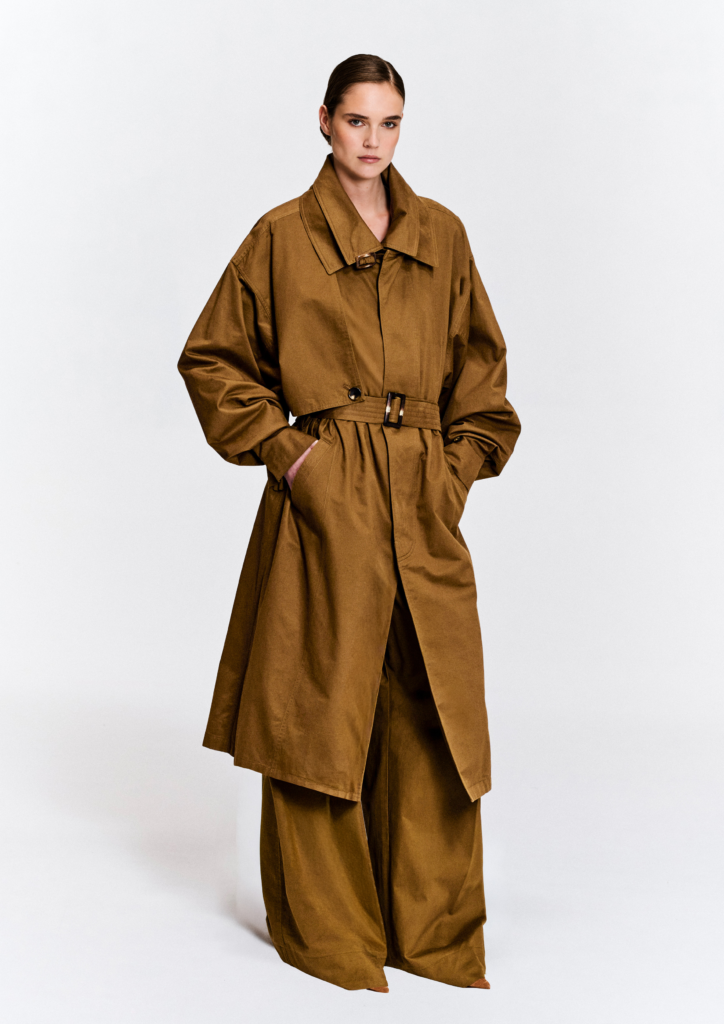 Model wearing the KIM C STUDIO oversized camel cotton trench coat, front view