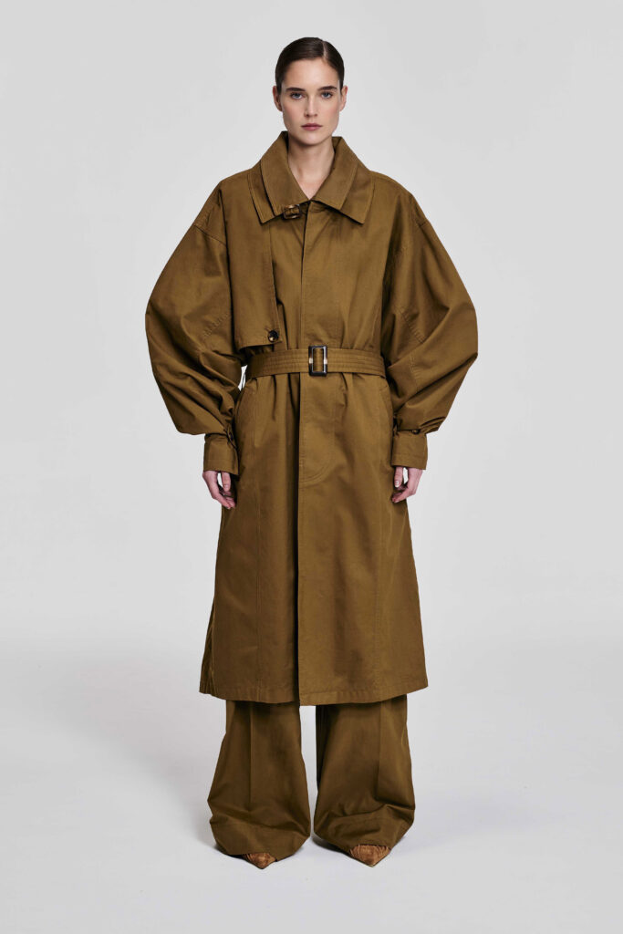 Model wearing the KIM C STUDIO oversized camel cotton trench coat, front view