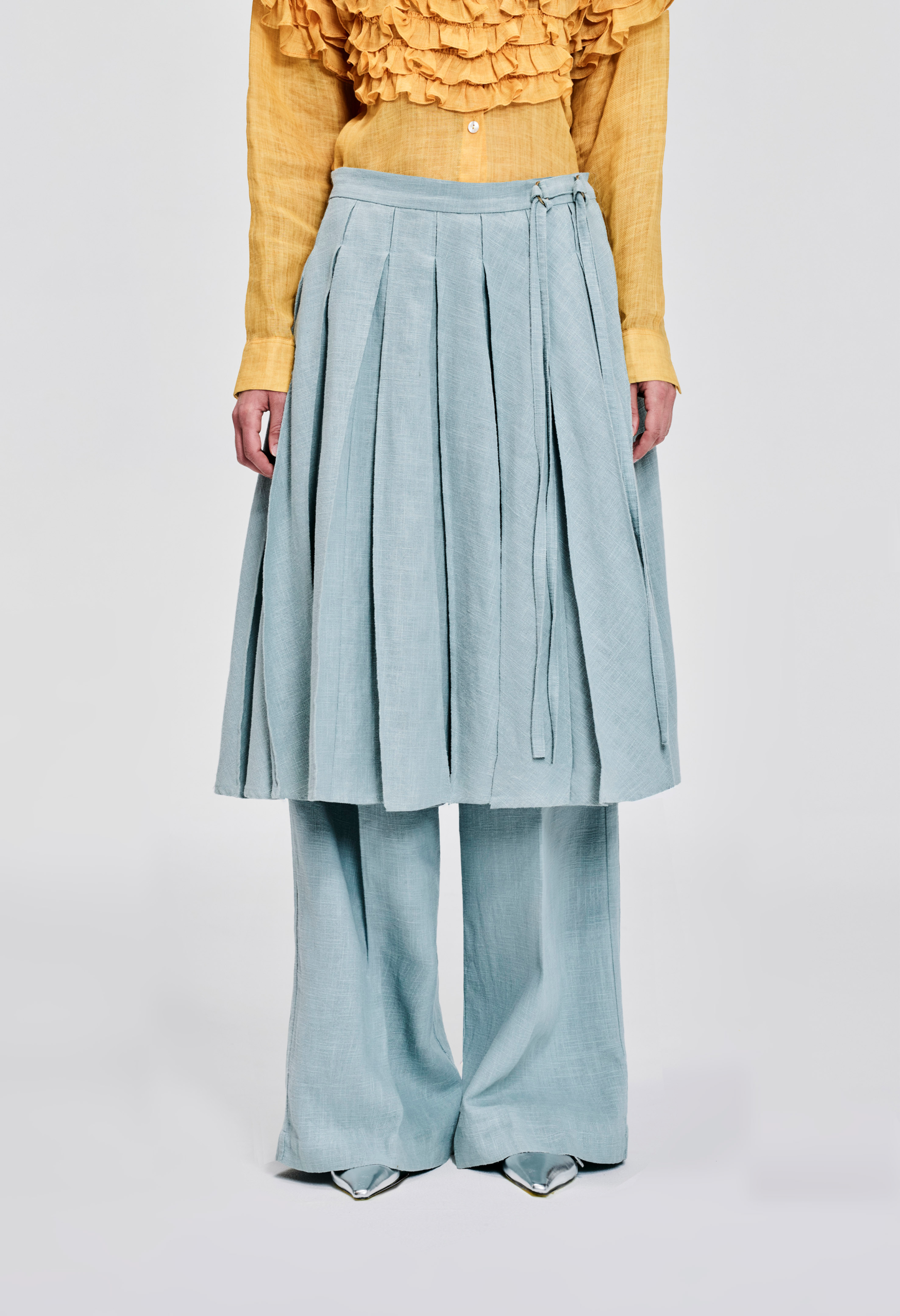 Front view of KIM C STUDIO pale blue linen pleated wrap skirt