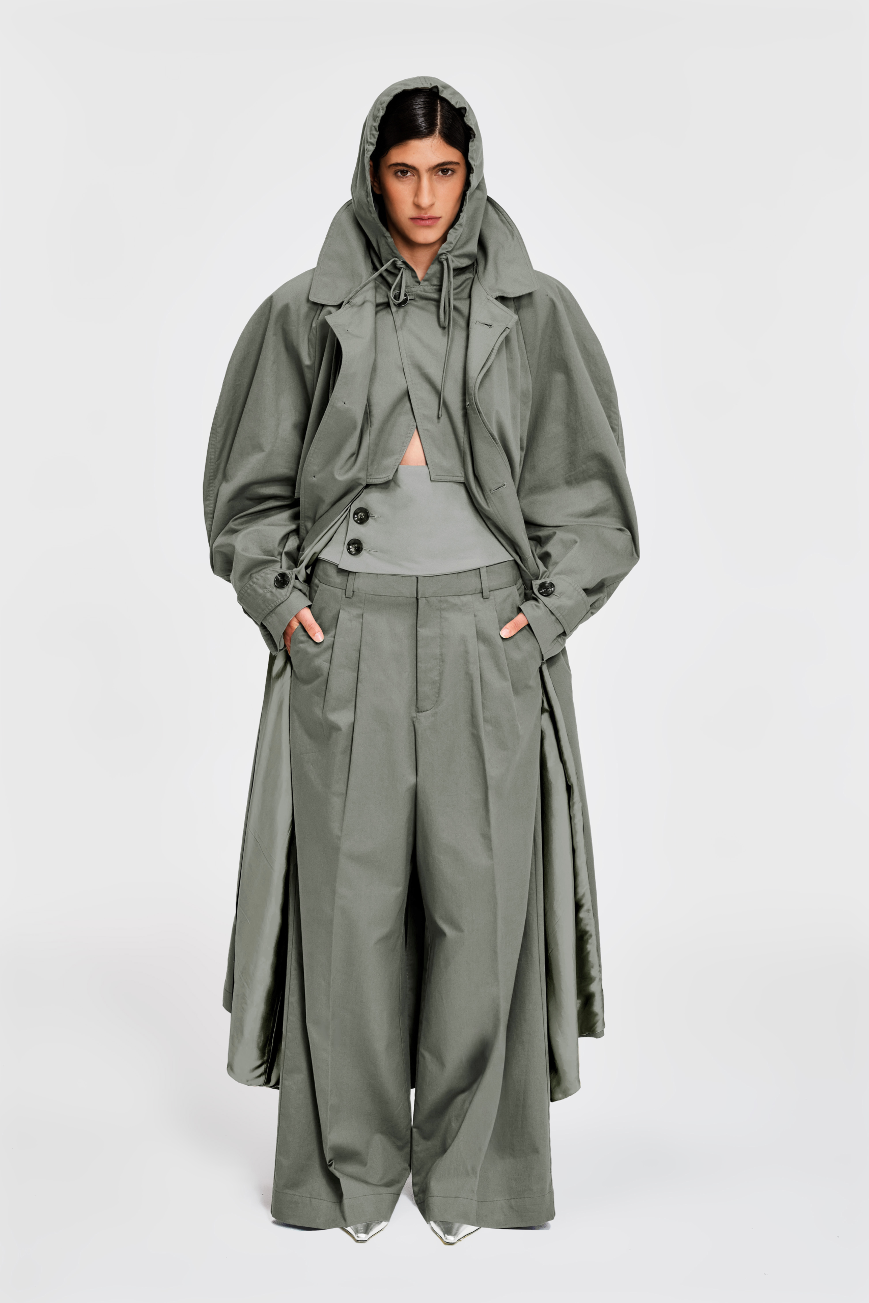 Detail view of full-length sage hooded cotton trench coat