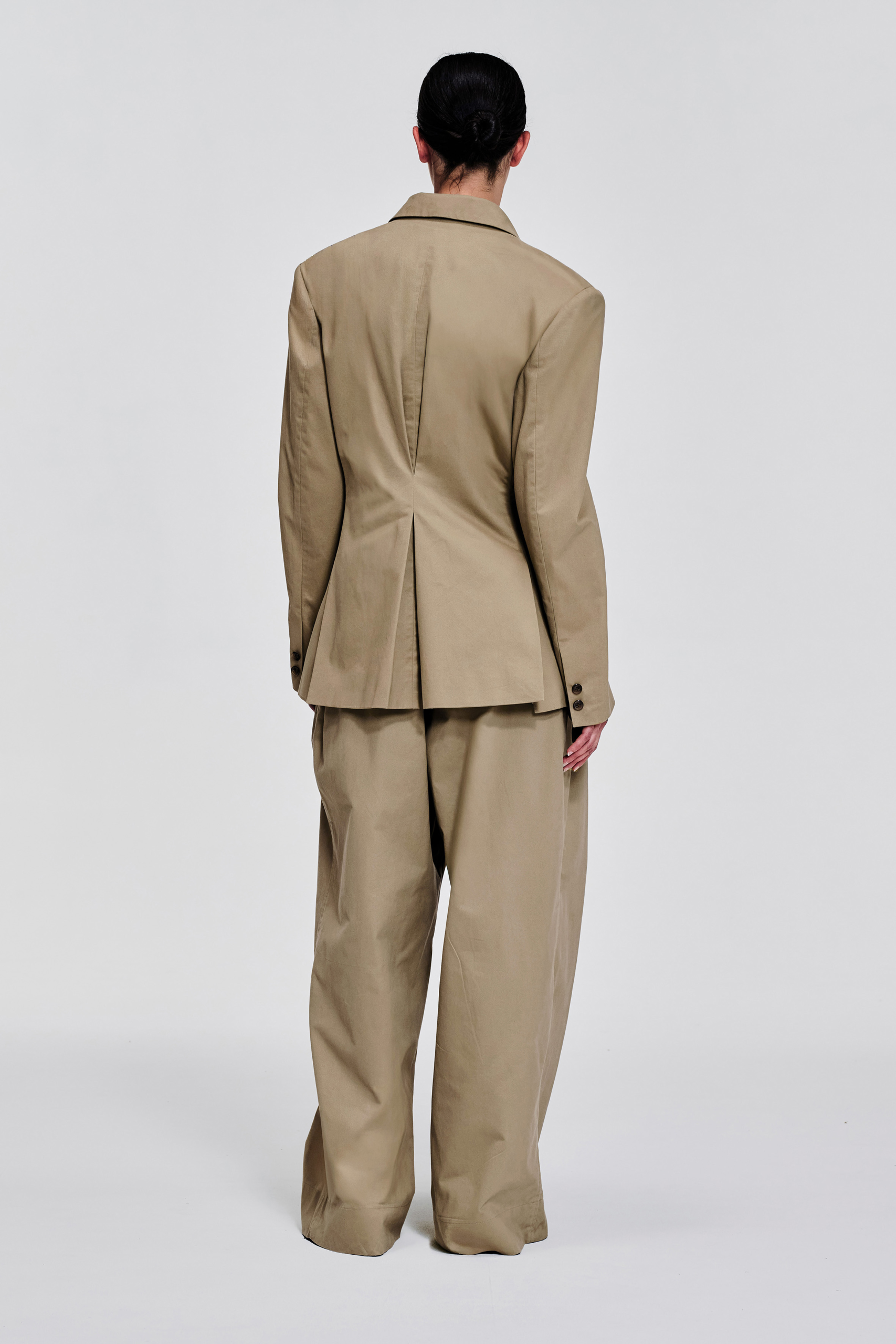 Back view of KIMC Studio Sculpted Pleat Cotton Blazer in sand