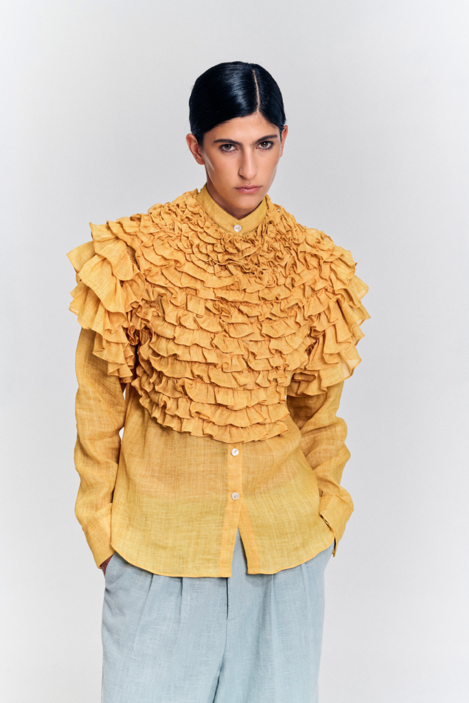 Front detail of the yellow hemp blouse showing cascading ruffles across the chest and shoulders